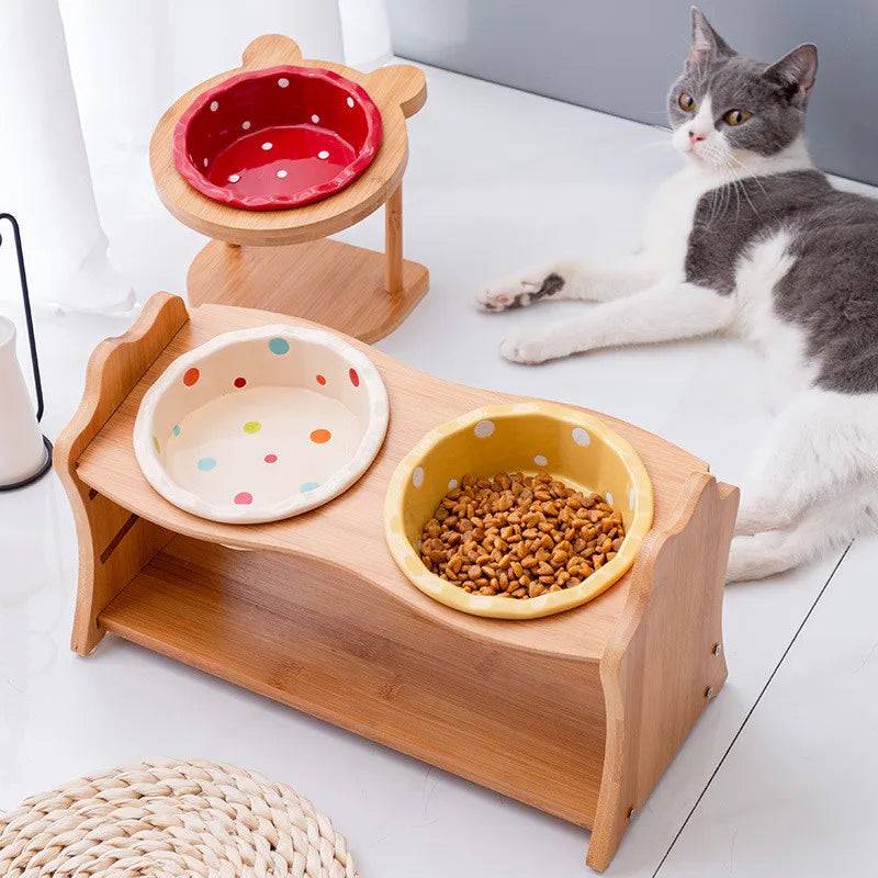 Raised ceramic double bowl stand for dogs and cats by Pawciara, featuring white bowls on a wooden stand for food and water.