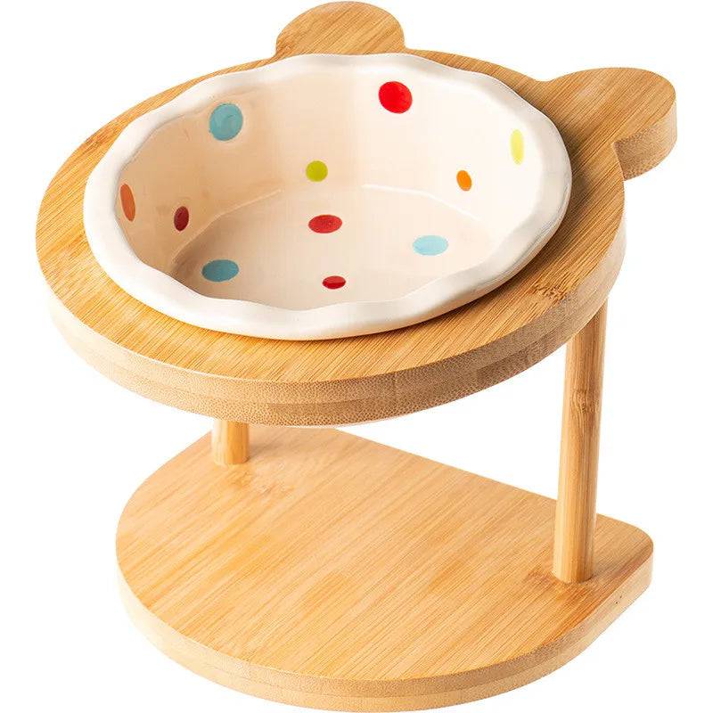 Raised ceramic double bowl stand for dogs and cats by Pawciara, featuring white ceramic dishes on a wooden stand for food and water.