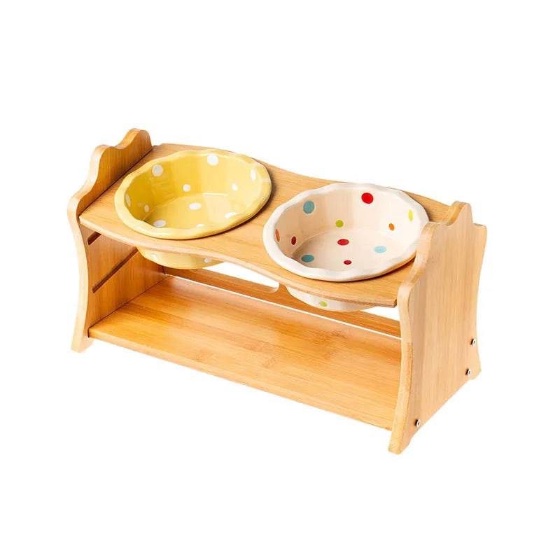 Raised ceramic double bowl stand for dogs and cats by Pawciara, featuring white ceramic bowls on a wooden stand for food and water.