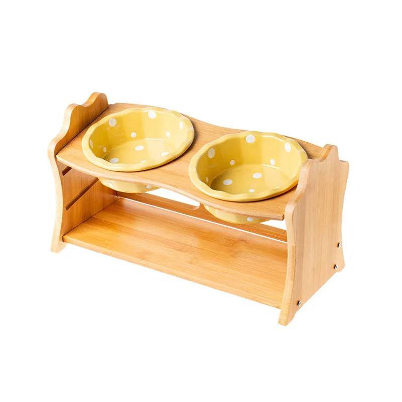 Raised ceramic double bowl stand for dogs and cats by Pawciara, featuring white food and water bowls on a wooden stand.