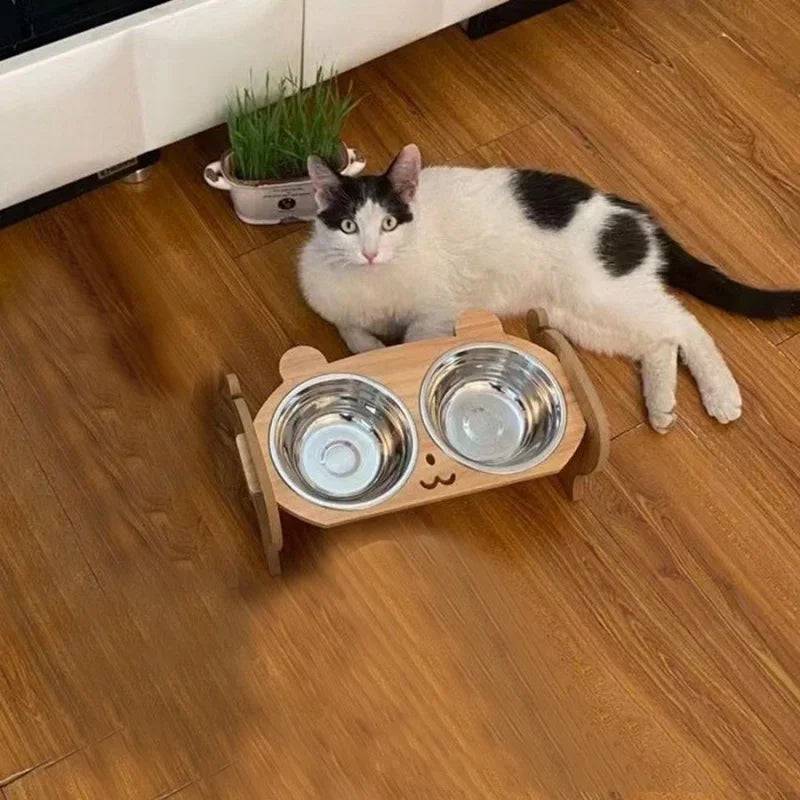 Pawciara double pet food and water bowl stand with anti-tip design for cats and dogs, featuring two stainless steel bowls.