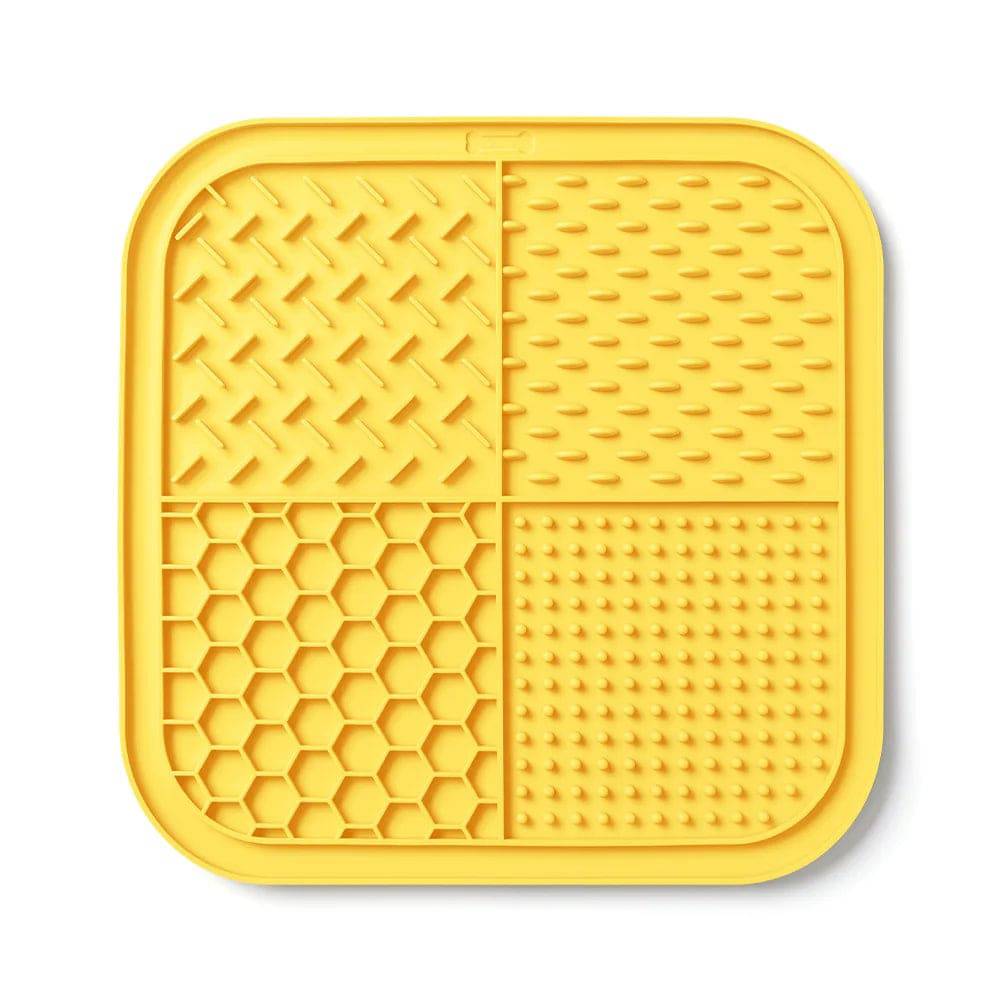 Yellow Pawciara lick mat for dogs and cats, anti-slip design, used for slow feeding, anxiety relief, and enrichment during grooming.