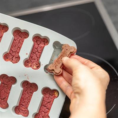 Trixie silicone baking mat for pet treats, bone shape, grey, 24 x 29 cm, designed for baking dog treats.