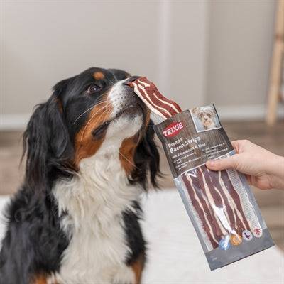 Trixie Premio Bacon Strips snack for dogs with duck breast and beef, 80g, showing bacon strips and meat pieces.