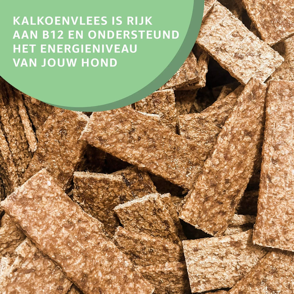 Woefwoefsnacks natural turkey strips dog treats, Hondenkoekjes, shown as six pieces on a white background.